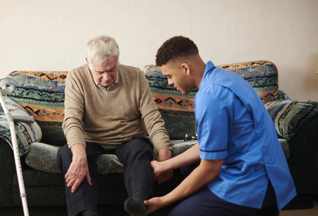 Male carer providing personal care